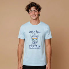 Person wearing a light blue t-shirt with a 'Motor Boat Captain' graphic on a beige background