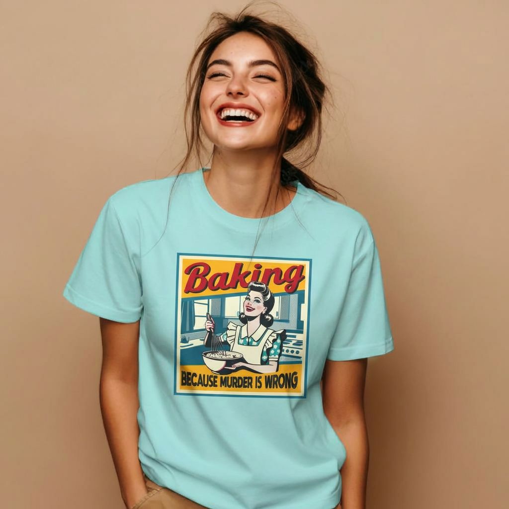 A woman wearing a funny baking shirt and laughing.