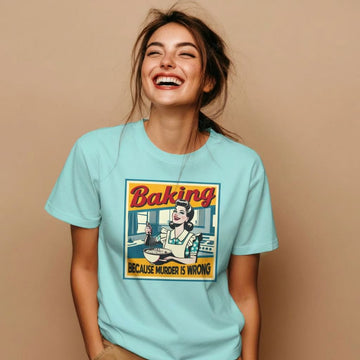 A woman wearing a funny baking shirt and laughing.