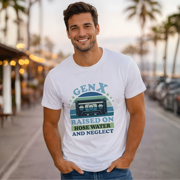 Man wearing a white t-shirt with a graphic design on a street with palm trees in the background