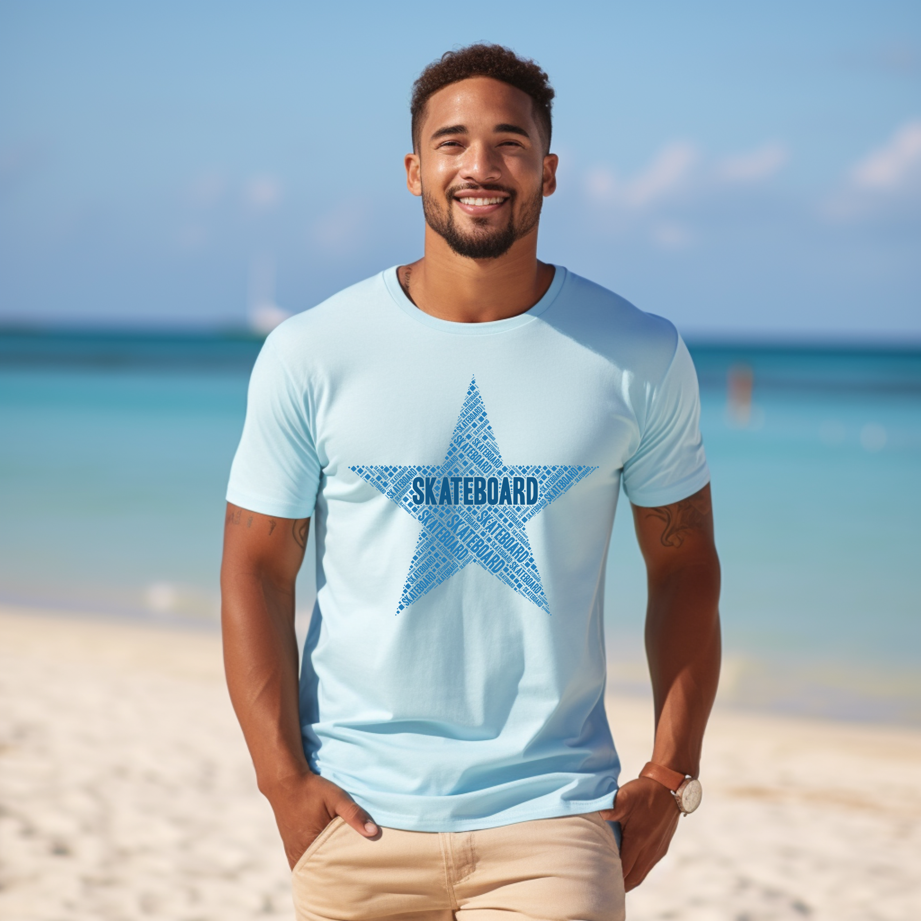 Man wearing a light blue t-shirt with a star graphic and 'SKATEBOARD' text on a beach.