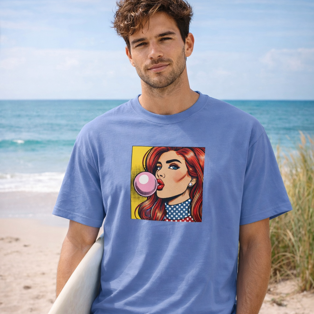 Man wearing a blue t-shirt with a graphic pop art design on a beach