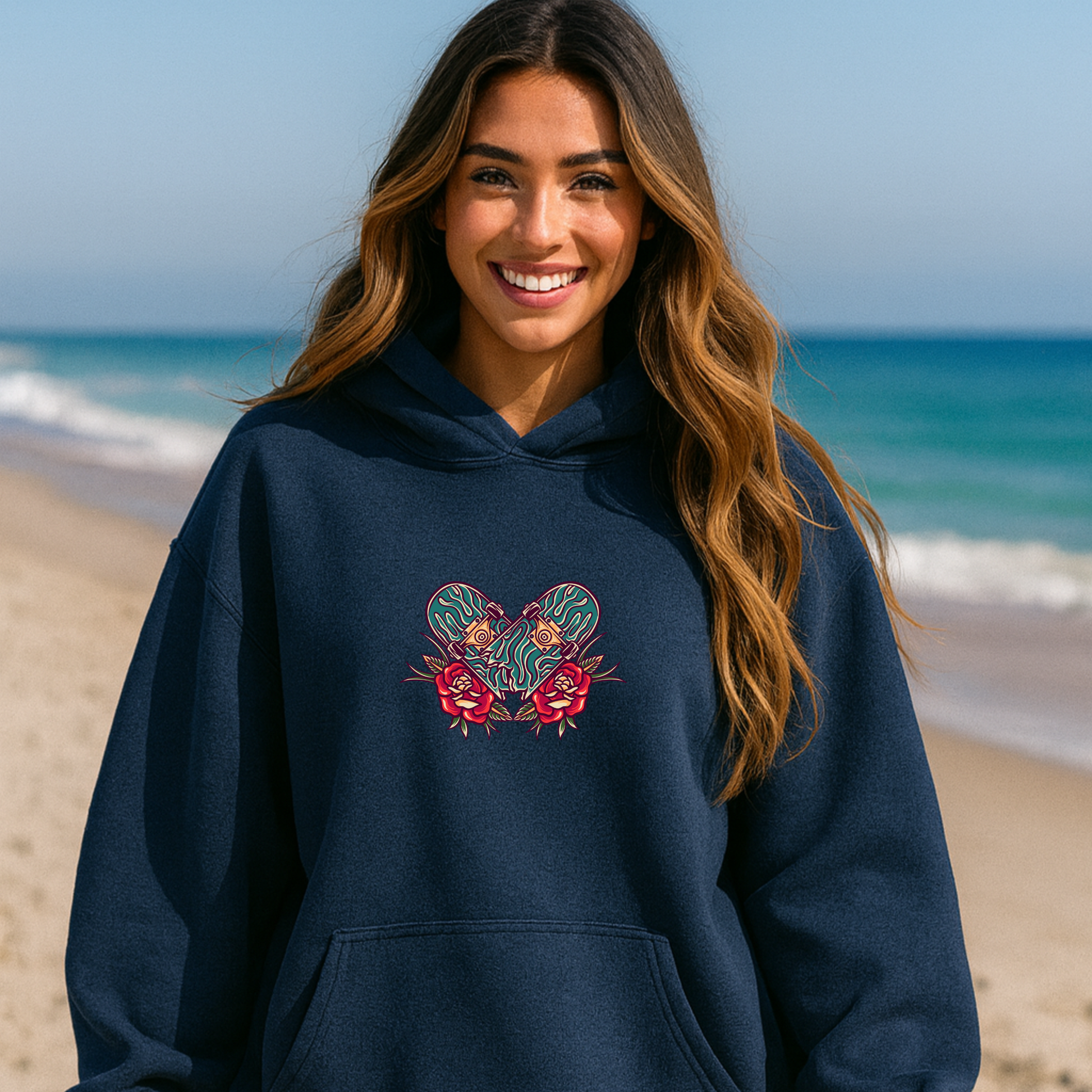 Woman wearing a navy blue skateboard hoodie with a colorful design on a beach