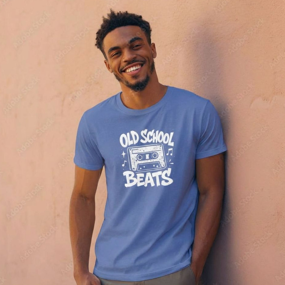 Man wearing a blue t-shirt with 'Old School Beats' design against a beige wall