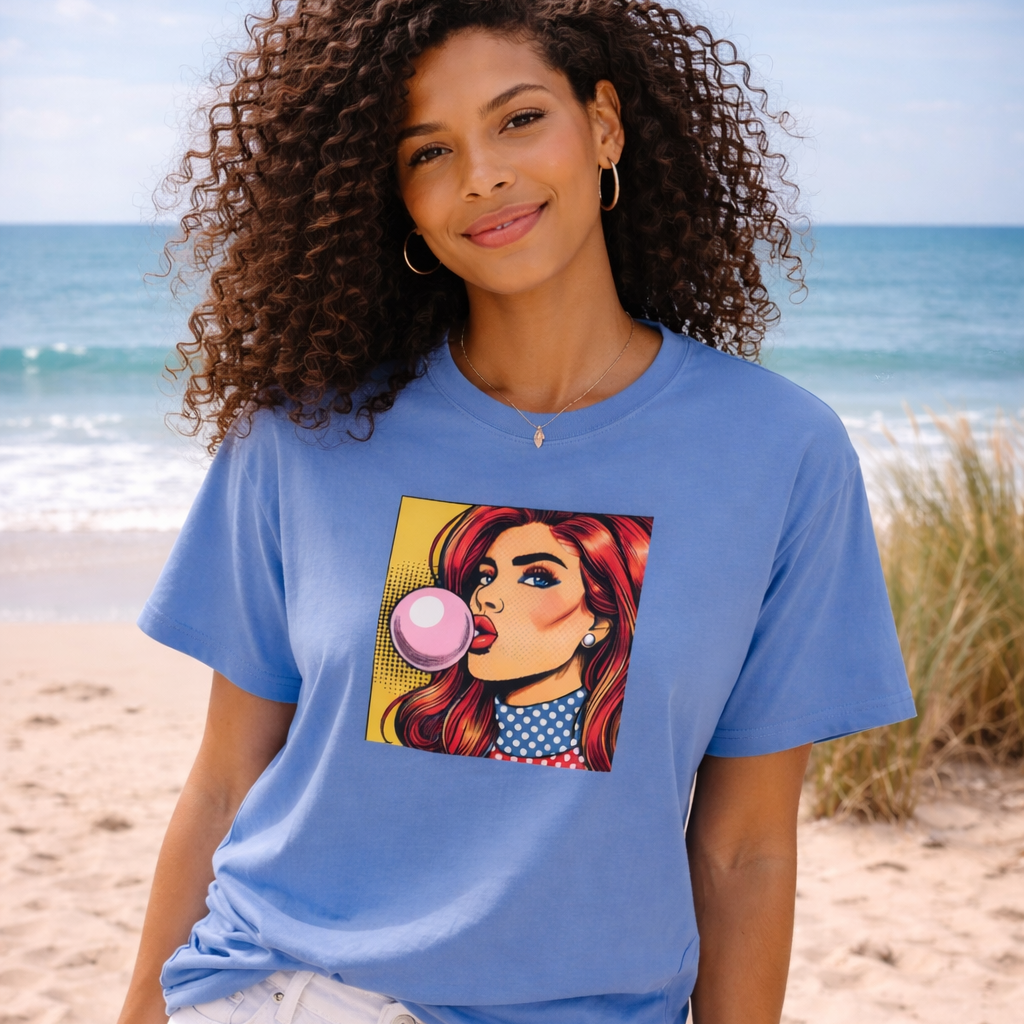 Woman wearing a blue pop art t-shirt with a graphic design on a beach