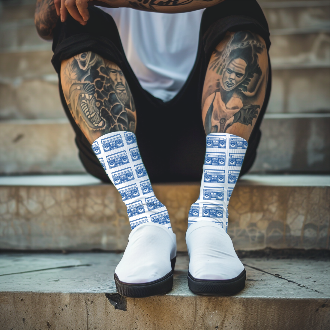 Knee-high socks with blue boom box pattern worn by a person on a plain background
