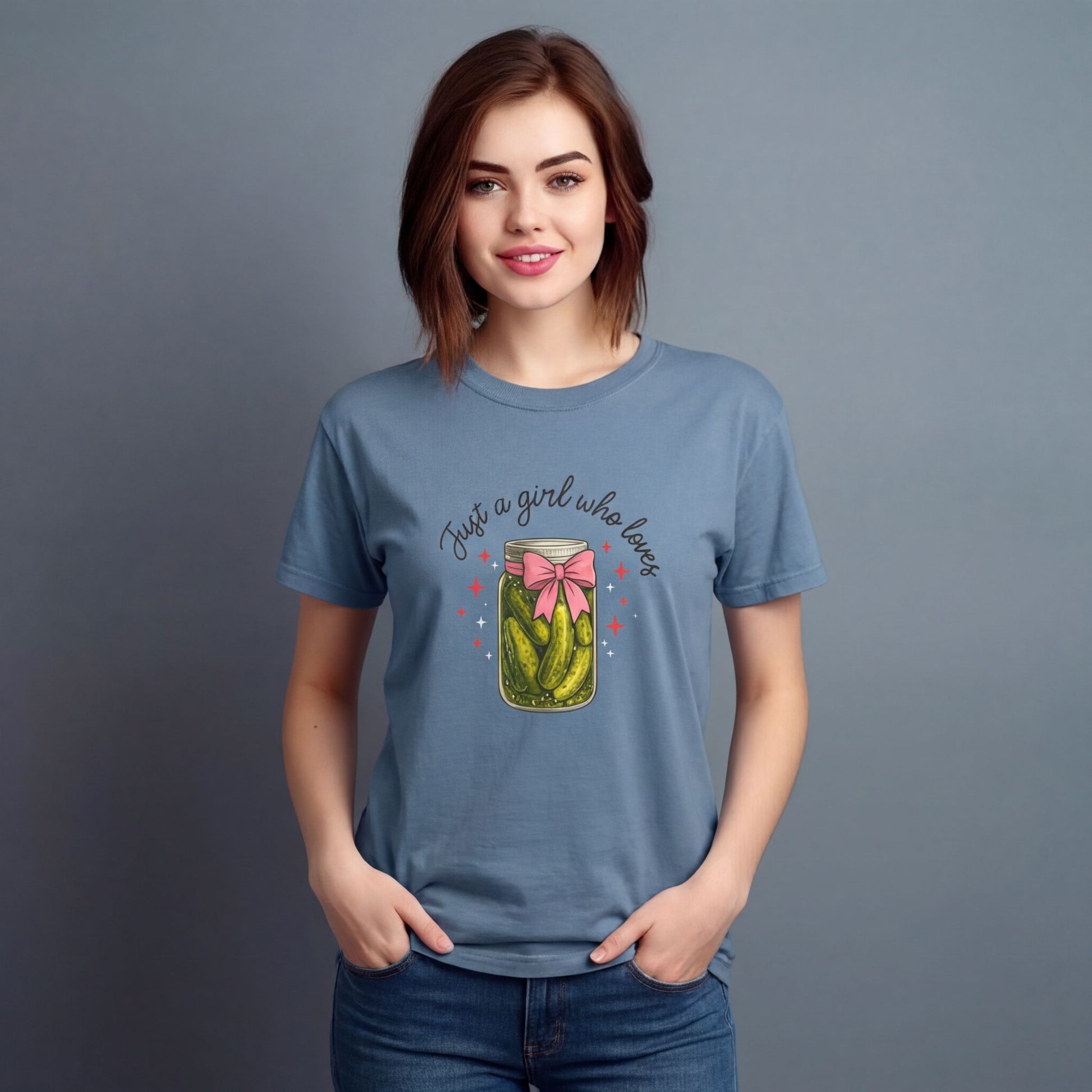 Woman wearing a blue t-shirt with a graphic design and text on a gray background