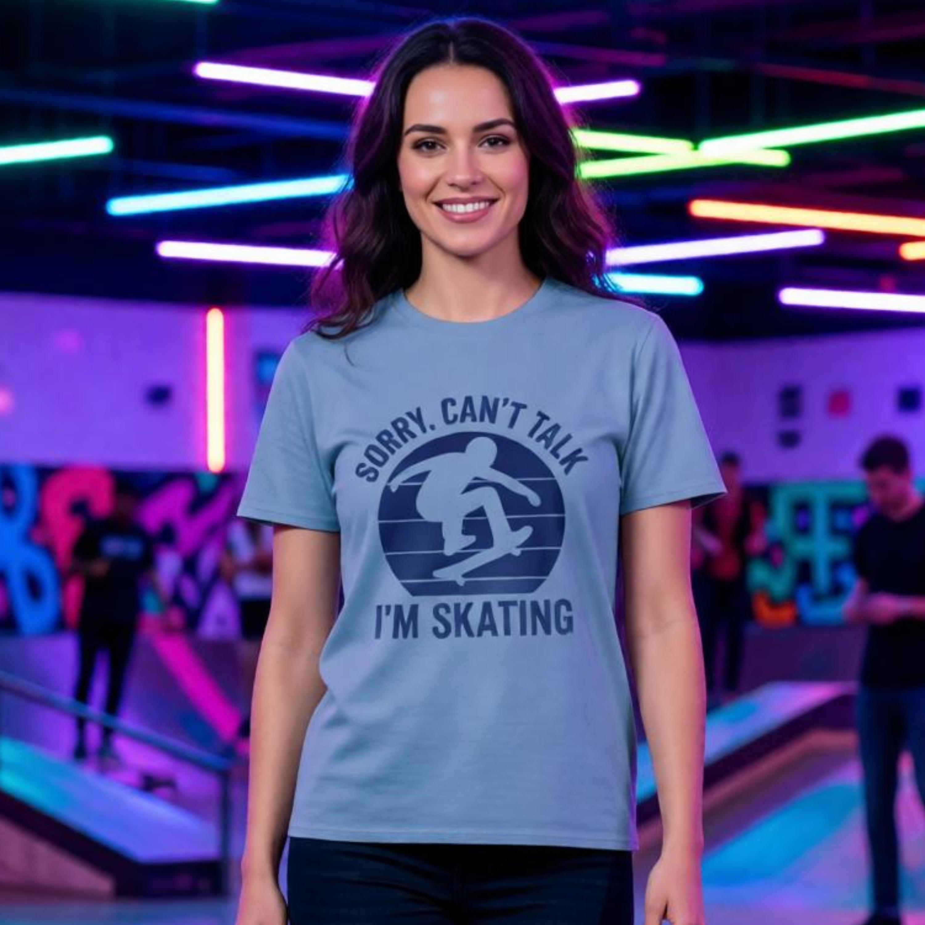 Woman wearing a t-shirt with 'Sorry, Can't Talk I'm Skating' design in a skate park setting.
