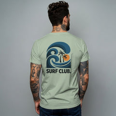 Man wearing a bay green t-shirt with 'Surf Club' design on the back against a gray background