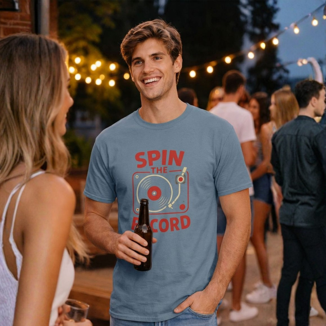 Man wearing a black t-shirt with 'Spin the Record' design on a city street.