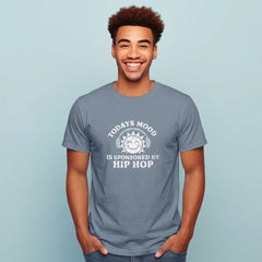 Man wearing a gray t-shirt with a humorous text design on a light blue background